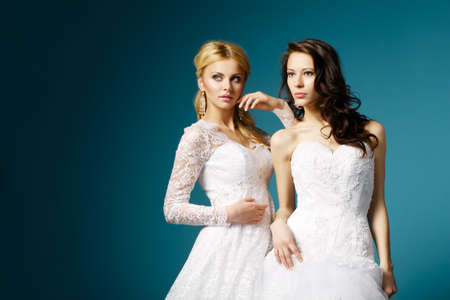 two lovely blonde and brunette brideの写真素材