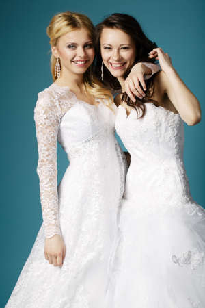 two lovely blonde and brunette brideの写真素材