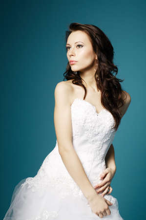 beautiful bride in wedding dress on blue backgroundの写真素材