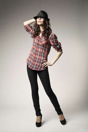 Beautiful brunette girl with black classic hatの写真素材