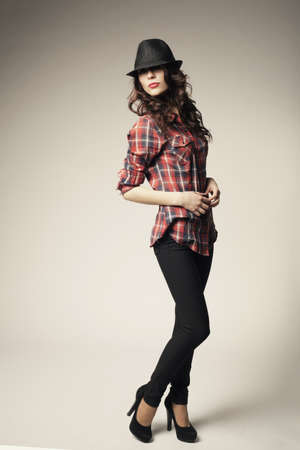 Beautiful brunette girl with black classic hatの写真素材