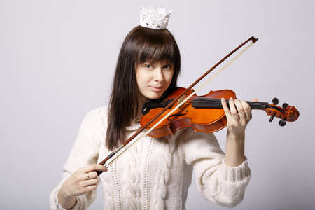 beautiful girl with violin studio shotの写真素材