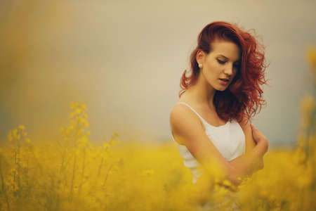 young beautiful girl in yellow fieldの写真素材