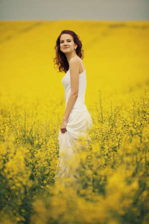 young beautiful girl in yellow field