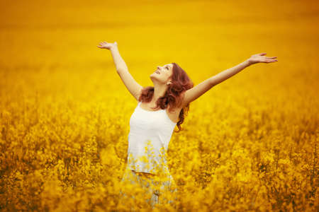 young beautiful girl in yellow fieldの写真素材