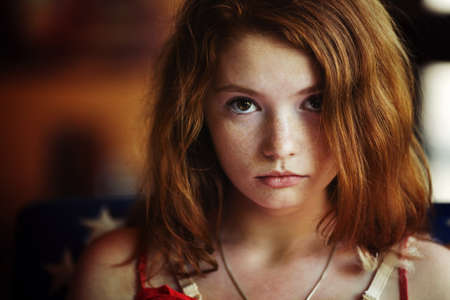 beautiful redheaded woman relaxing in a cafe