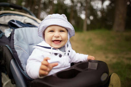 little funny baby portrait in baby carriageの写真素材