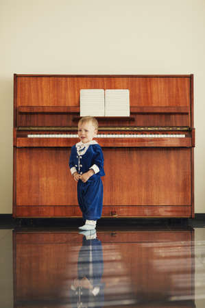 little funny boy plays pianoの写真素材