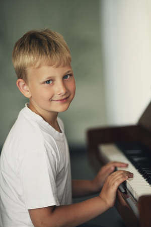 little funny boy plays pianoの写真素材