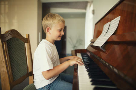 little funny boy plays pianoの写真素材