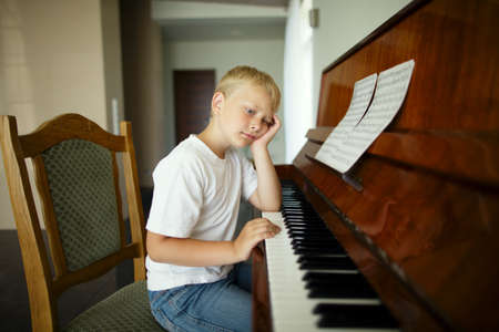 little funny boy plays pianoの写真素材
