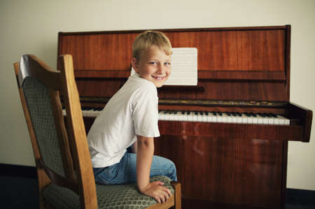 little funny boy plays pianoの写真素材