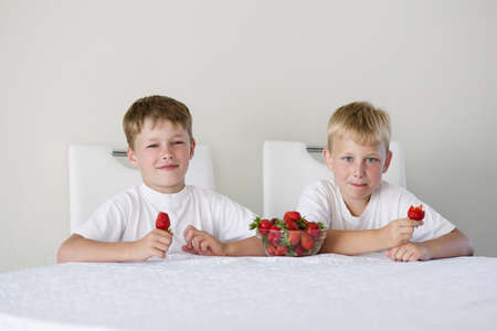 little funny boy with strawberriesの写真素材