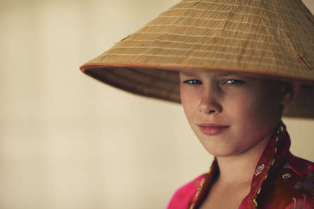 little boy with asian straw haatの写真素材