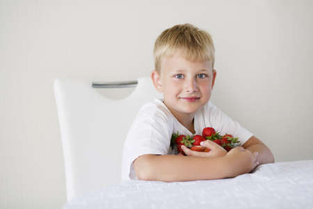 little funny boy with strawberriesの写真素材
