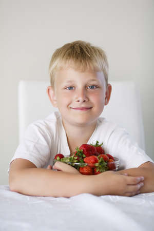 little funny boy with strawberriesの写真素材