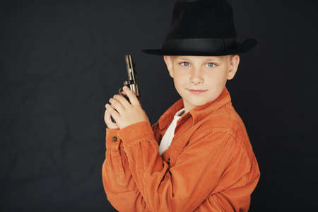 little boy with black hat and gunの写真素材