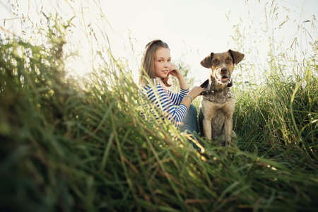beautiful teen girl with dogの写真素材