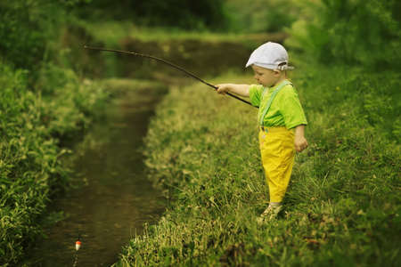 photo of little cute boy fishingの写真素材
