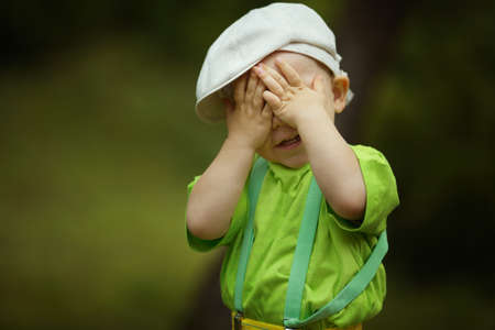 little funny boy plays hide and seek