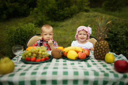 cute boy and girl on picnic in parkの写真素材