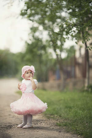 cute little girl in dress outdoor photoの写真素材
