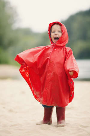 little funny girl with raincoatの写真素材
