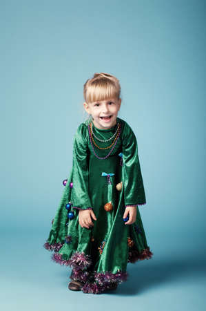 cute little girl with christmas tree dressの写真素材