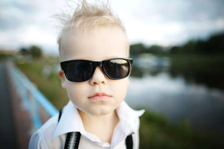 little gentleman with sunglasses outdoorsの写真素材