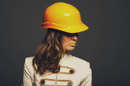 Beautiful girl with yellow helmet portraitの写真素材