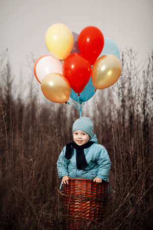 little boy wants to fly on balloons awayの写真素材