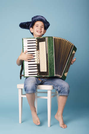 little funny accordion player on blue backgroundの写真素材