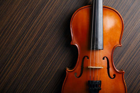 aged handmade violin on wooden table の写真素材