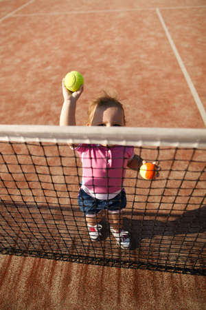little funny girl plays tennisの写真素材