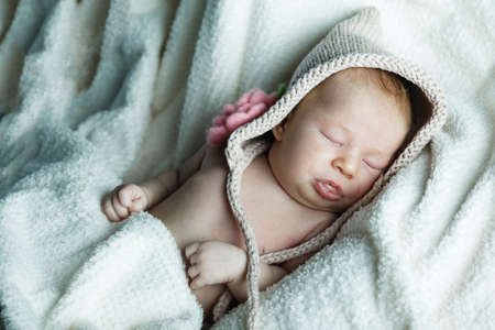 cute little funny sleepeng baby with hatの写真素材