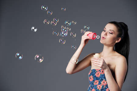 beautiful brunette girl with bubblesの写真素材