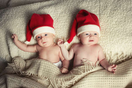 cute babies with santa hatsの写真素材