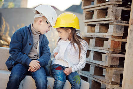boy and girl playing on construction siteの写真素材