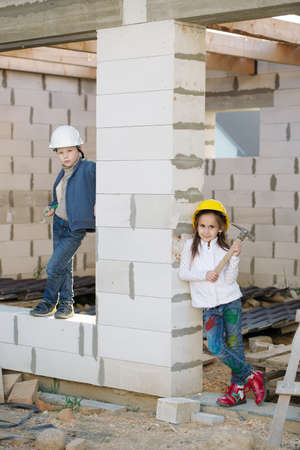 boy and girl playing on construction siteの写真素材