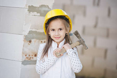 little girl with helmet working on constructionの写真素材