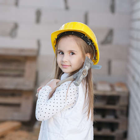 little girl with helmet working on constructionの写真素材