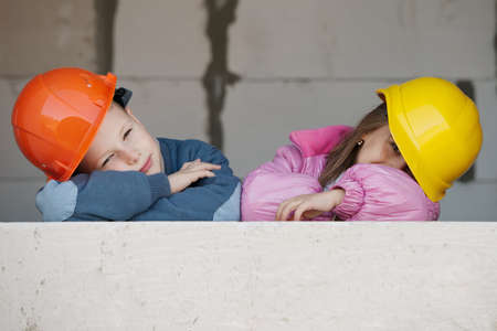 boy and girl playing on construction siteの写真素材