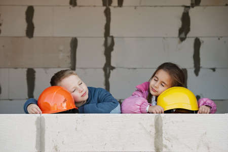 boy and girl playing on construction siteの写真素材