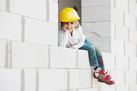 little girl with helmet working on constructionの写真素材