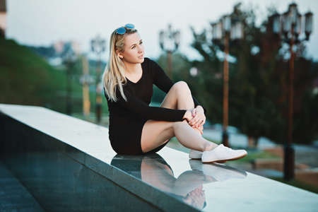 beautiful blonde girl portrait on the streetの写真素材