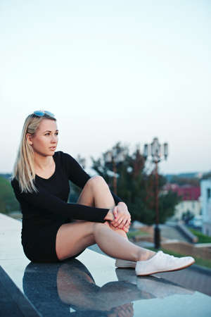 beautiful blonde girl portrait on the streetの写真素材