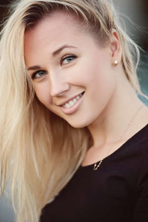 beautiful blonde girl portrait on the streetの写真素材