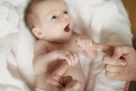 little baby keeps mom\'s fingersの写真素材