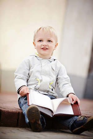 little boy reads a bookの写真素材