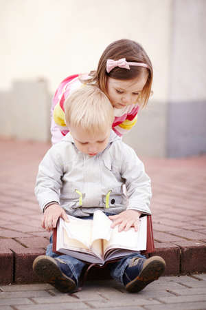 boy and girl reading a bookの写真素材